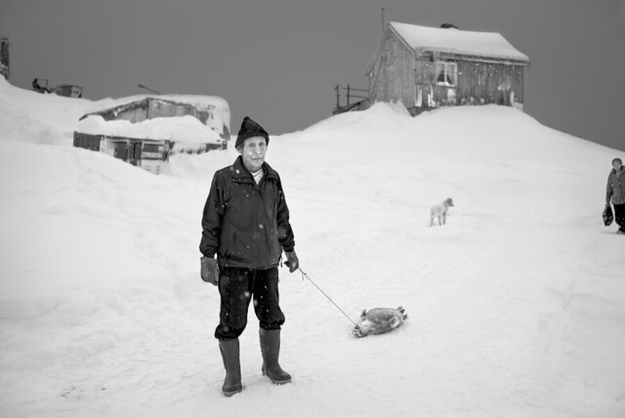 Hunter with a seal, Tiniteqilaaq, Greenland