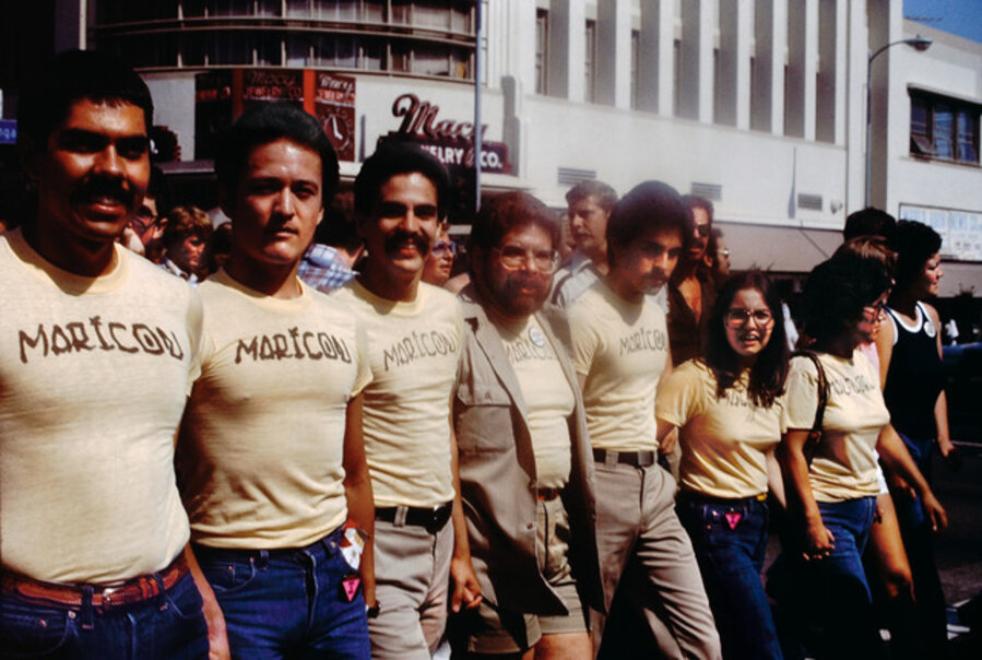 Participants in the Christopher Street West Pride parade wearing Joey Terrill’s malflora and maricón T-shirts