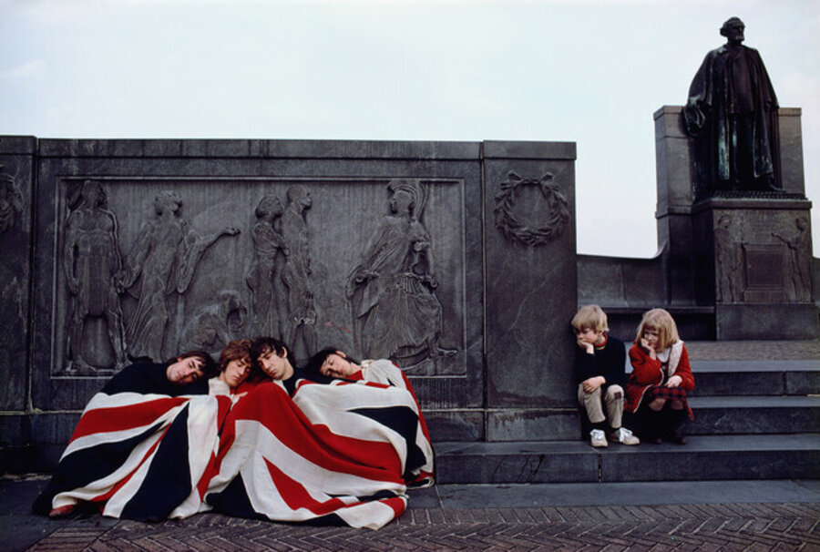 The Who under a Union Jack with children watching