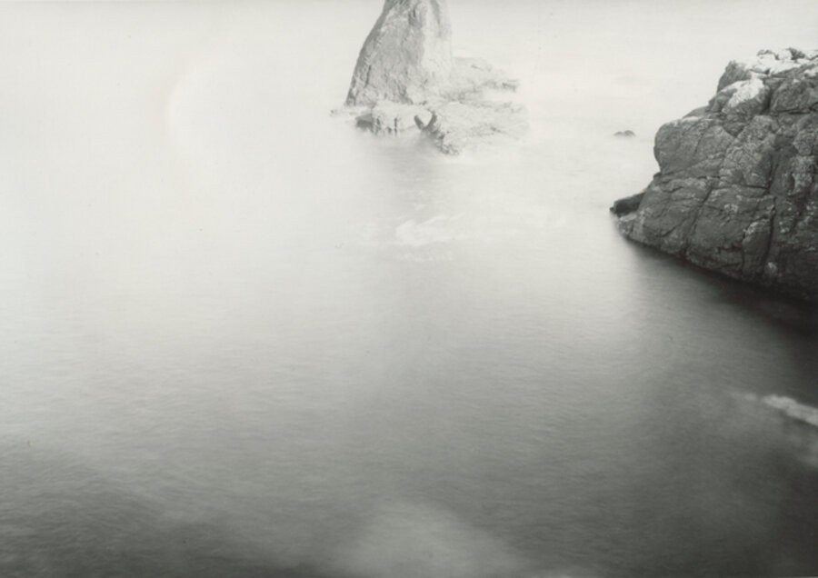 bright Summer sea-haze, The Celtic Sea and the English Channel, Bumble Rock, The Lizard, Cornwall, England. The southmost point of Cornwall and the South most point of mainland Britain
