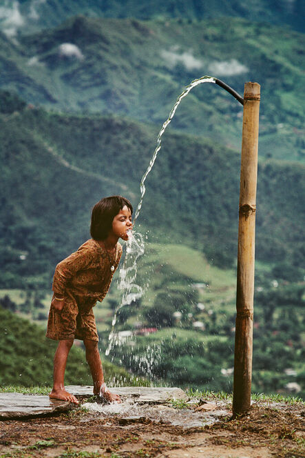 Steve McCurry, ‘Child Drinks Water from Well, Nepal’, 1983