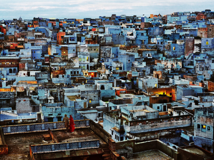 Blue City. Couple looking over balcony at the vibrant city. Jodhpur, Rajasthan, India