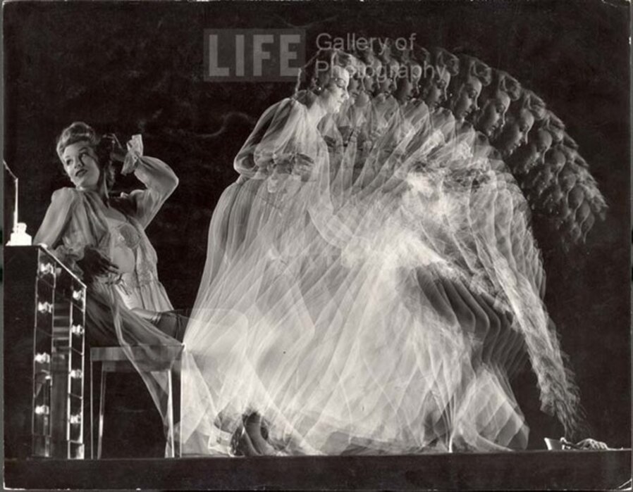 Stroboscopic of Model Clad in Girdle, Bra, Stockings and Negligee Seated at Dressing Table and Moving to Pick Up Slippers