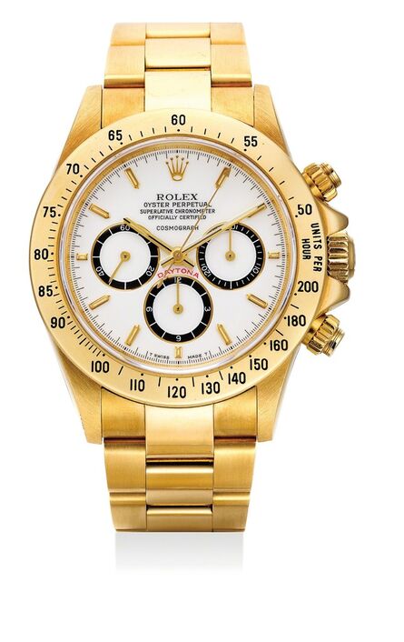 Rolex, ‘A fine and very rare yellow gold chronograph wristwatch with “Floating Cosmograph” white porcelain dial, bracelet, warranty and presentation box’, 1988