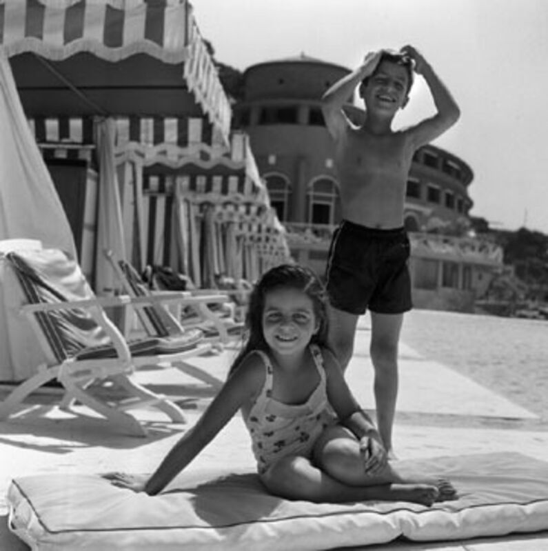 Slim Aarons, ‘Young and Carefree, 1958: Christina and Alexander Onassis enjoying the sunshine at the Monte Carlo Beach Club’, 1958, Photography, Gelatin Silver Print, Staley-Wise Gallery