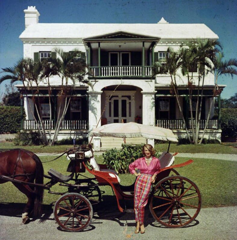 Slim Aarons, ‘Bermudan Hostess: Polly Trott Hornburg in front of her father's house’, 1957, Photography, C-Print, Staley-Wise Gallery