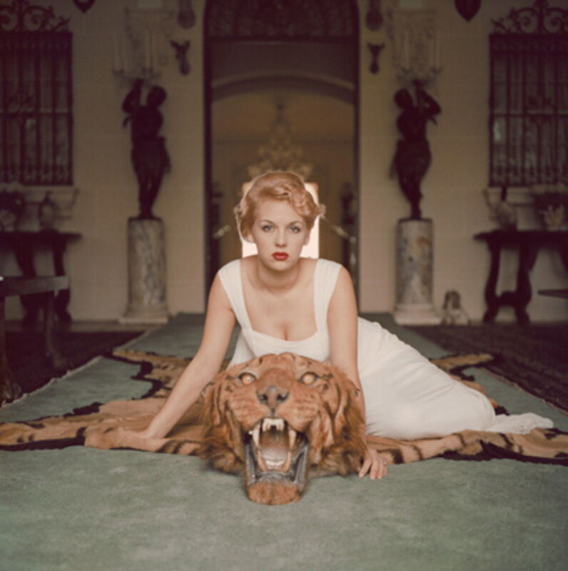 Slim Aarons, ‘Beauty And The Beast, 1959: Lady Daphne Cameron (Mrs George Cameron) on a tiger skin rug in the trophy room at socialite Laddie Sanford's home, Palm Beach’, 1959, Photography, C-Print, Staley-Wise Gallery