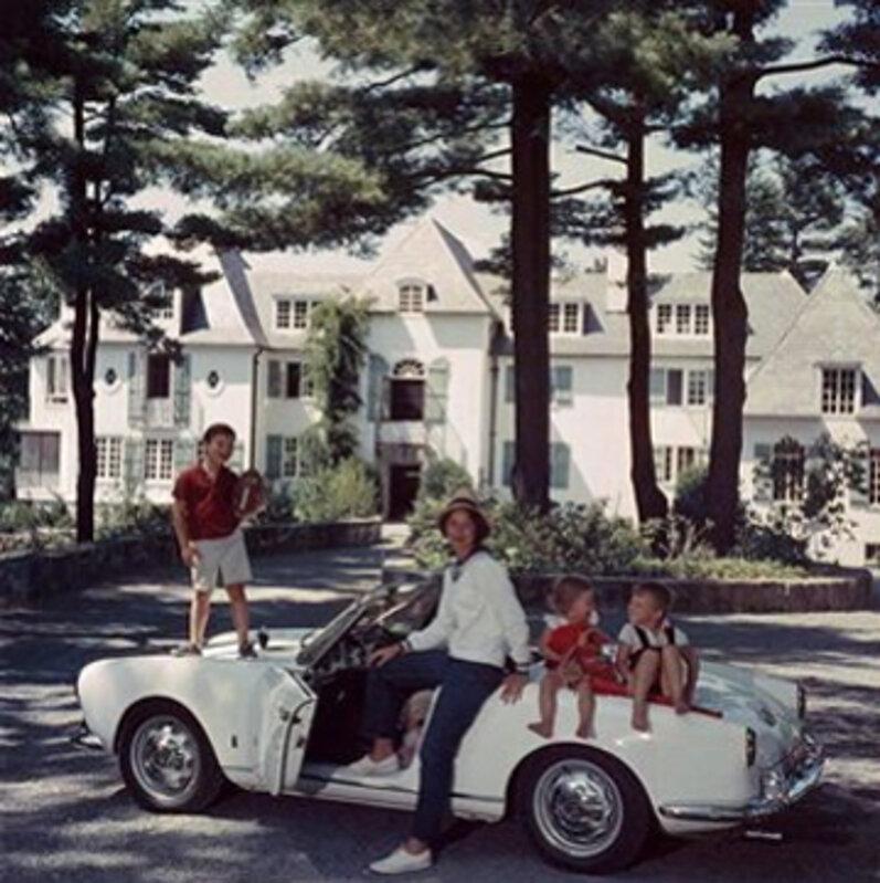 Slim Aarons, ‘Mrs. Henry Cabot with her children sitting on a car in the driveway of their home, 'Rollingstones', Manchester, New Hampshire, c. 1960’, 1960, Photography, C-Print, Staley-Wise Gallery
