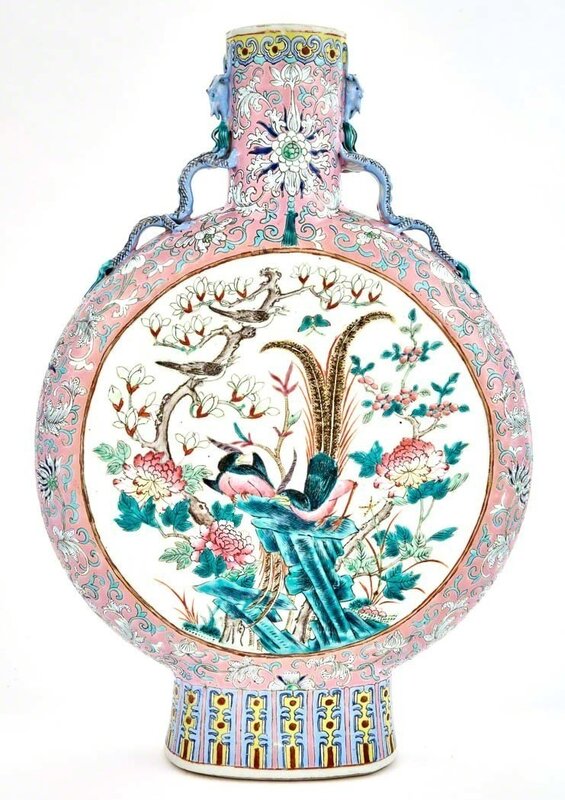 ‘Pair of Chinese Famille Rose Glazed Porcelain Moonflasks’, Design/Decorative Art, Each flattened globular body rising from a spread foot to a tall cylindrical neck, the neck flanked by a pair of chilong handles, each side decorated with a gilt rimed medallion enclosing a scene of two pheasants perched on stylized rockwork amongst chrysanthemum, magnolia, and peony blossoms, the reverse with further birds amongst rockwork and flowering plants and blooms, all reserved on a pink ground with scrolling lotus between lappet and ruyi bands., Doyle