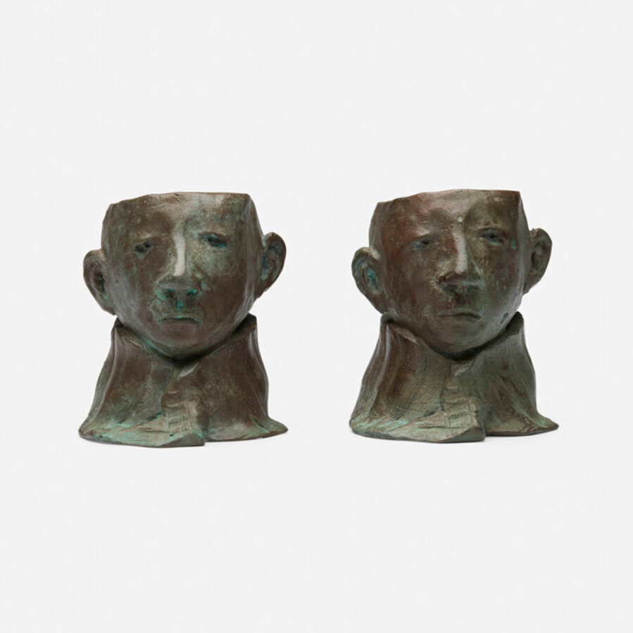 A set of two bronze egg cups