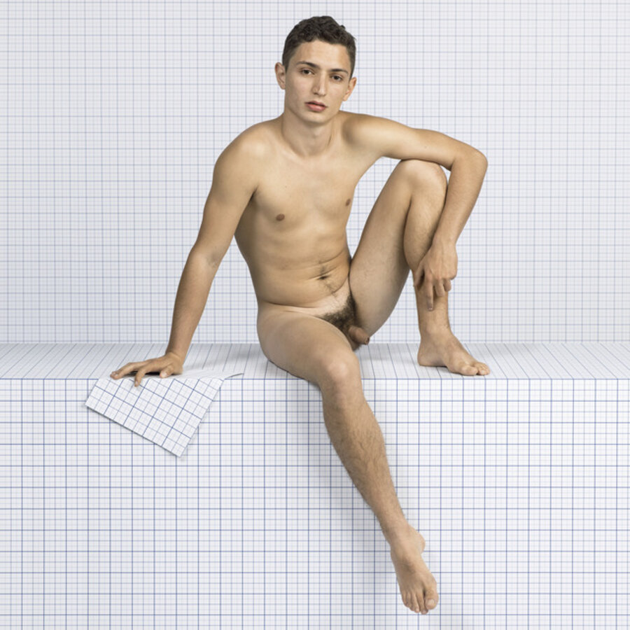 Naked Boy Sitting Down, Looking Towards Camera