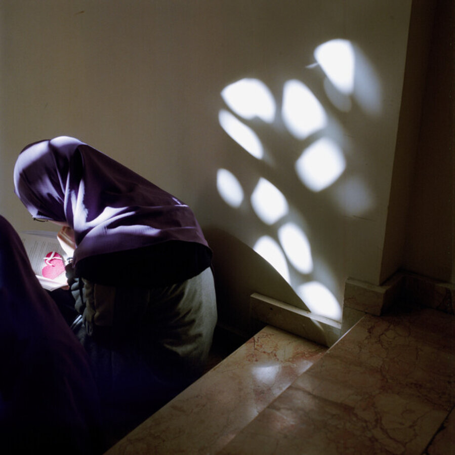 A student studies on the steps in the hallway, Istanbul