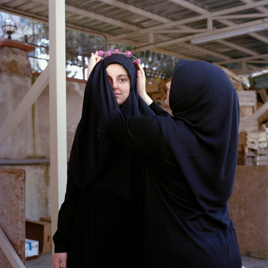 Sisters crowning each other with a handmade garland. Istanbul