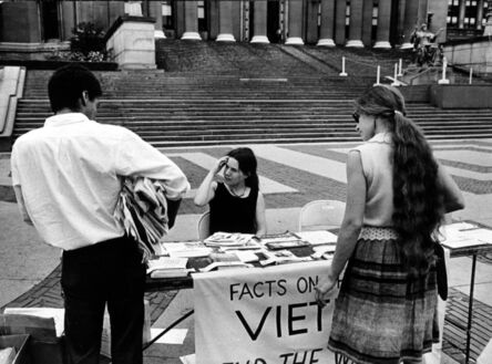 Garry Winogrand, ‘Columbia University Student Amelia Rechel Handing Out Anti-Vietnam War Literature at Information Table on Campus, NYC’, 1966