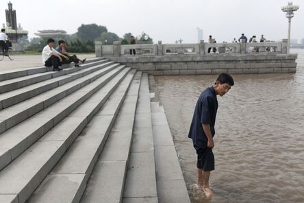 Tomas van Houtryve, ‘A man wades into the Tae Dong river where banks are flooded high above the normal water level in Pyongyang, North Korea’, 2007