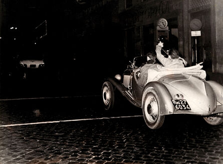 Tazio Secchiaroli, ‘The photohraphers rlo Bavagnoli and Enrico Sarsini chasing Ava Gardner's car after got a flat tire’