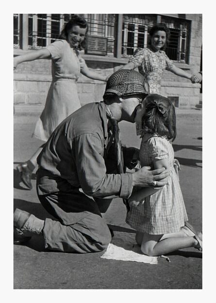 Tony Vaccaro, ‘Kiss of Liberation: : Sergeant Gene Costanzo kneels to kiss a little girl during spontaneous celebrations in the main square of the town of St. Briac, France, August 14, 1944 ’