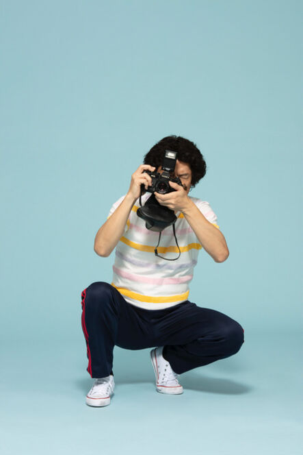 Leung Chi Wo + Sara Wong, ‘Photographer Squatting In A Colour-Striped T-Shirt And Blue Sweatpants’, 2019