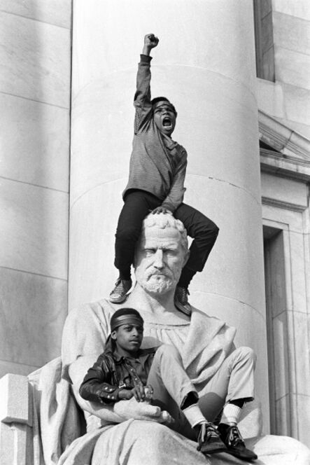 Stephen Shames, ‘Boy gives raised fist salute on a statue in front of the New Haven County Courthouse during a protest against the Bobby Seale and Ericka Huggins trial, New Haven, Connecticut’, 1970