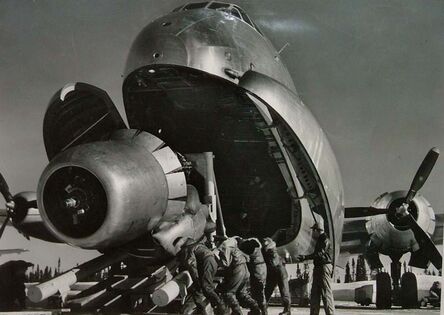 Margaret Bourke-White, ‘Crewmen Unloading Huge B-50 Bomber Plane Engine Used as a Spare from the Belly of a C-124 Cargo Plane upon Arrival at Strategic Air Command's Base, Greenland, TX’, 1951