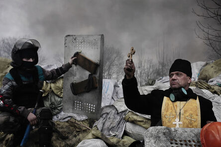 Jerome Sessini, ‘An Orthodox priest blesses the protesters on a barricade. Kiev, Ukraine.’, 2014