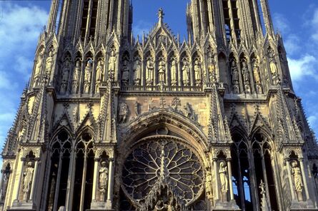 ‘Reims Cathedral: exterior, detail of West facade showing tracery of West Rose Window and gable over central portal (Coronation of the Virgin)’, ca. 1211-1290