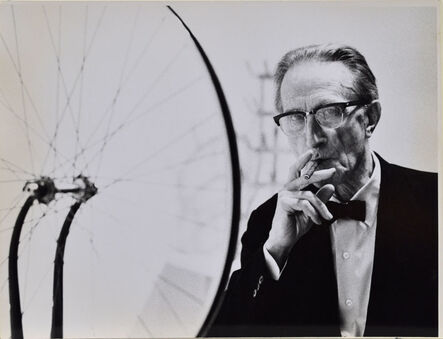 Julian Wasser, ‘Duchamp smoking Cigar next to Bicycle Wheel, Duchamp Retrospective, Pasadena Art Museum’, 1963