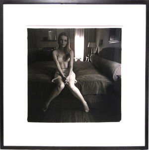 Mia Villiers-Farrow on a bed