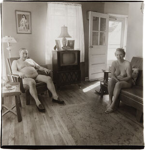 Retired man and his wife at home in a nudist camp one morning, N.J.