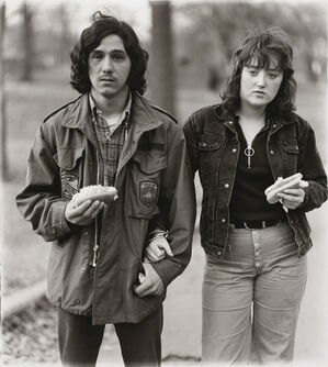 A young man and his girlfriend with hot dogs in the park, N.Y.C. 1971