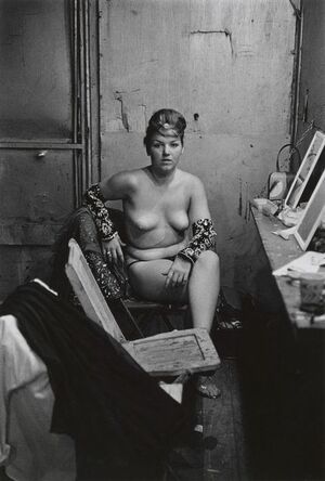 Stripper with bare breasts sitting in her dressing room, Atlantic City, N.J.