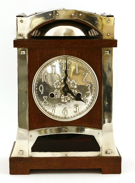 ‘A Continental oak and silver-plated mantel clock’