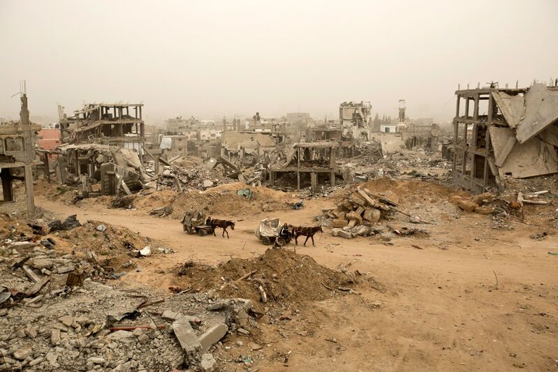 Agence France-Presse, ‘Palestinians ride donkey carts during a sandstorm next to buildings destroyed during Operation Protective Edge (Tsuk Eitan), the 50-day war between Israel and Hamas-led militants, in al-Shejaiya neighborhood in Gaza City’, 2015, Photography, Ronald Feldman Gallery