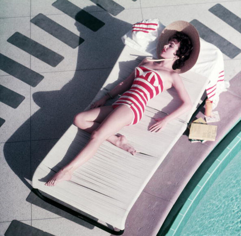 Slim Aarons, ‘Mara Lane at The Sands, 1954: Austrian actress Mara Lane lounging by the pool in a red and white striped bathing costume, Las Vegas’, 1954, Photography, C-Print, Staley-Wise Gallery