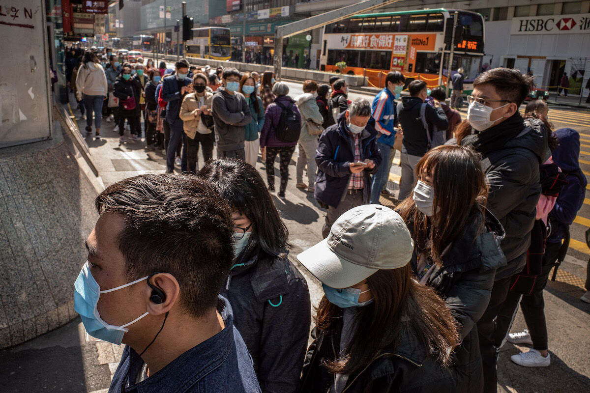 Residents wait to buy face masks from a Hong Kong pharmacy. Photo by Anthony Kwan/Getty Images.