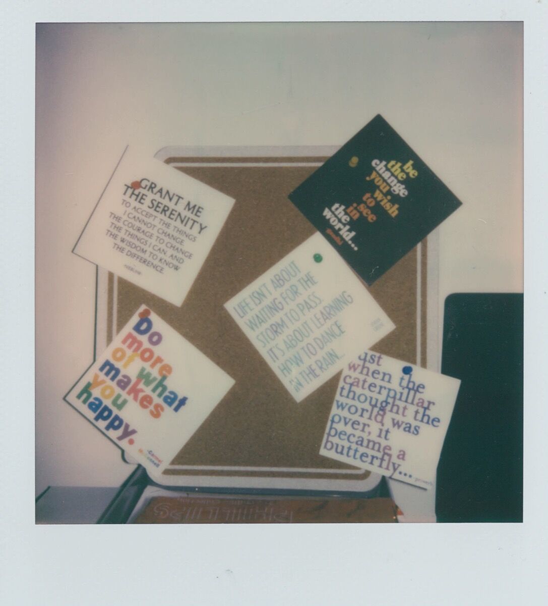 Cheerful postcards pinned to a small pinboard above Clay’s desk feature positive affirmations: “Be the change you wish to see…,” “Grant me the serenity….”