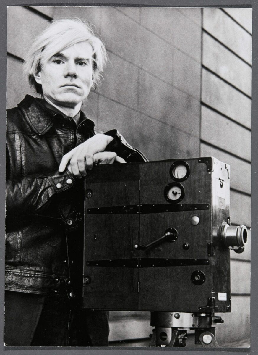Andy Warhol, Self Portrait (Andy Warhol with film camera taken during the heyday of his Factory films), 1977. Courtesy of the Agnès b. Collection.