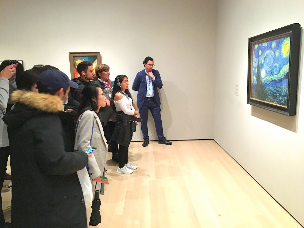 Visitors at the Museum of Modern Art look at a painting by the Dutch artist Vincent van Gogh. Photo by wyliepoon, via Flickr.