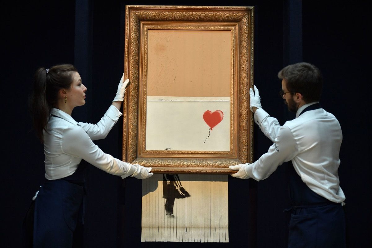 Banksy, Love Is in the Bin, 2018. Photo by Ben Stansall/AFP via Getty Images.