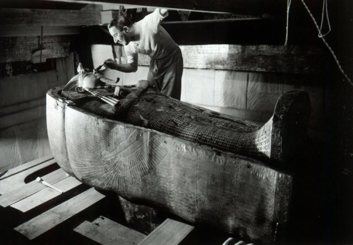 Howard Carter in King Tutankhamen&#x27;s                    tomb, ca. 1925. Photo by Harry Burton. Image via                    Wikimedia Commons.