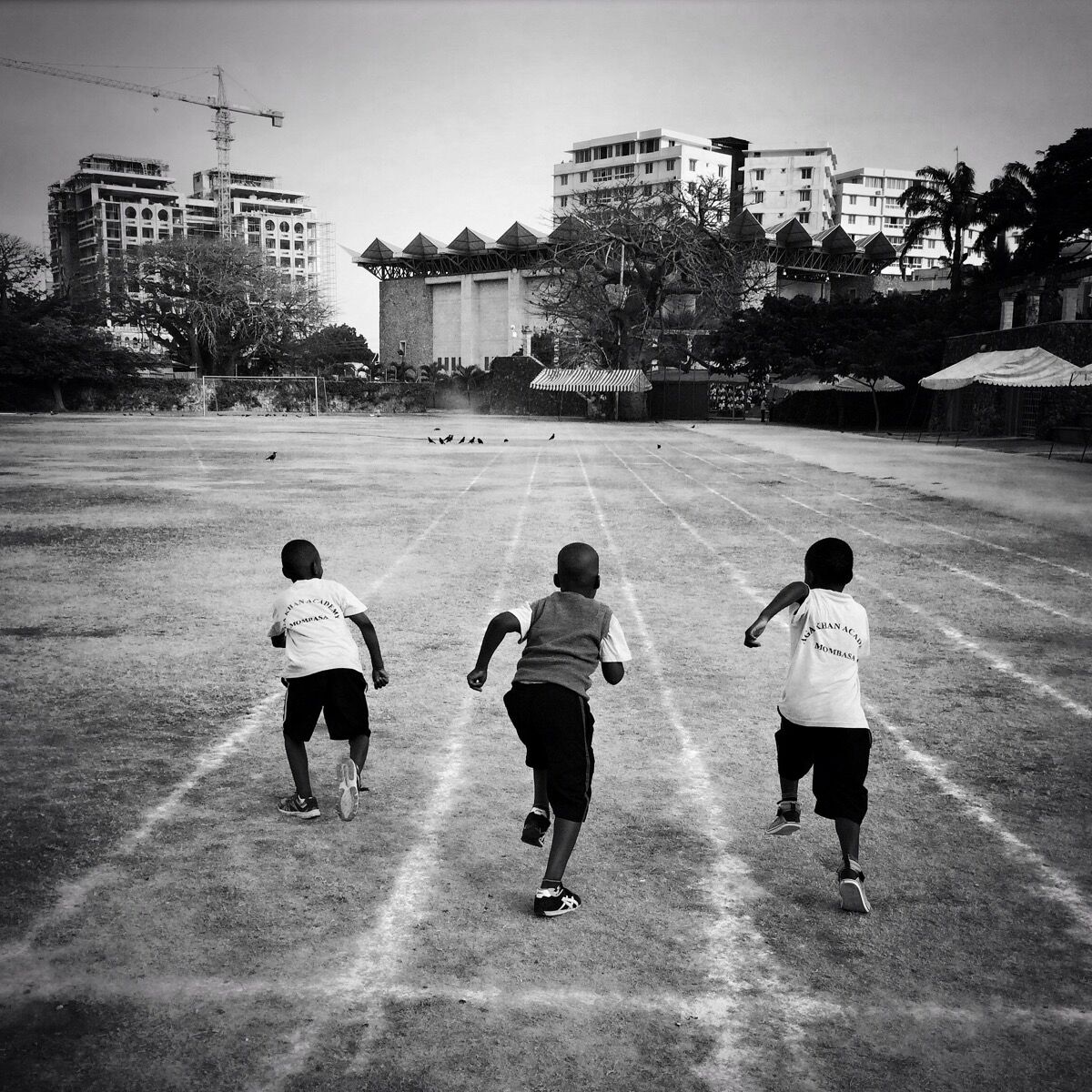 Three boys from the junior school of Aga Khan Academy in Mombasa,Kenya, race on the school’s track before the morning assembly. Photo by @austin_merrill.