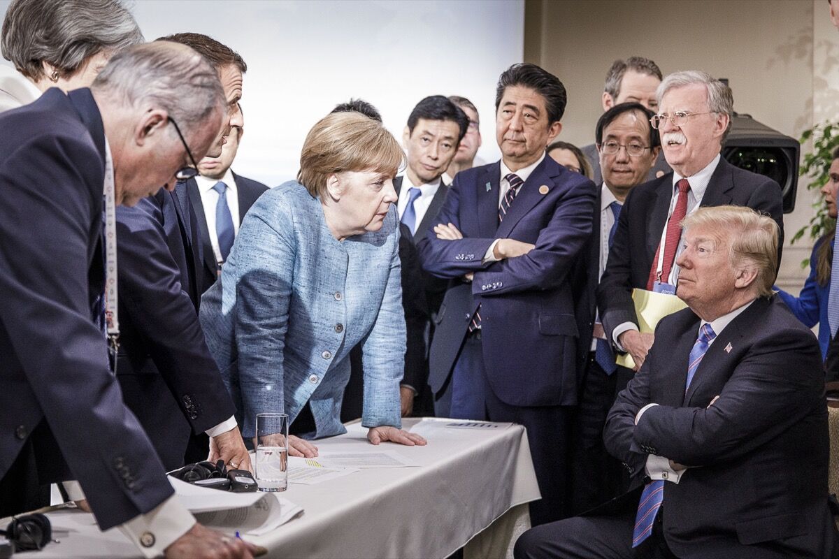 German Chancellor Angela Merkel deliberates with US president Donald Trump on the second day of the G7 summit on June 9, 2018  in Charlevoix, Canada. Photo by Jesco Denzel /Bundesregierung via Getty Images.