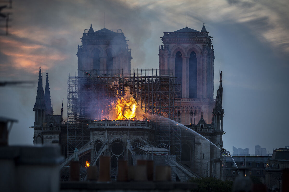 A devastating fire raged inside Notre Dame Cathedral in Paris as the sky darkened on April 15, 2019. Photo by Veronique de Viguerie/Getty Images.