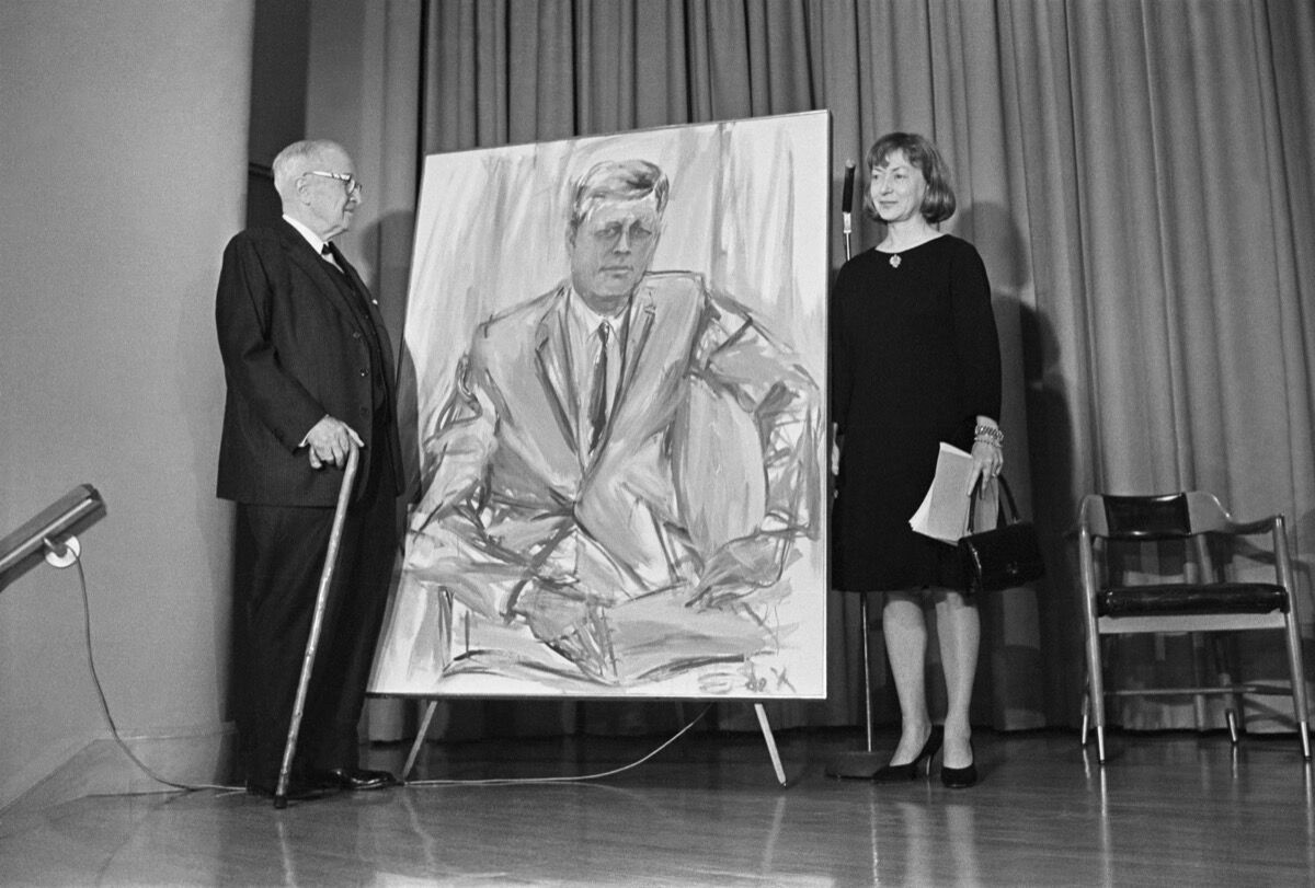 Former President Harry S. Truman and Elaine de Kooning stand next to a painting of John F. Kennedy, commissioned for the Truman Library. Photo via Getty Images. 