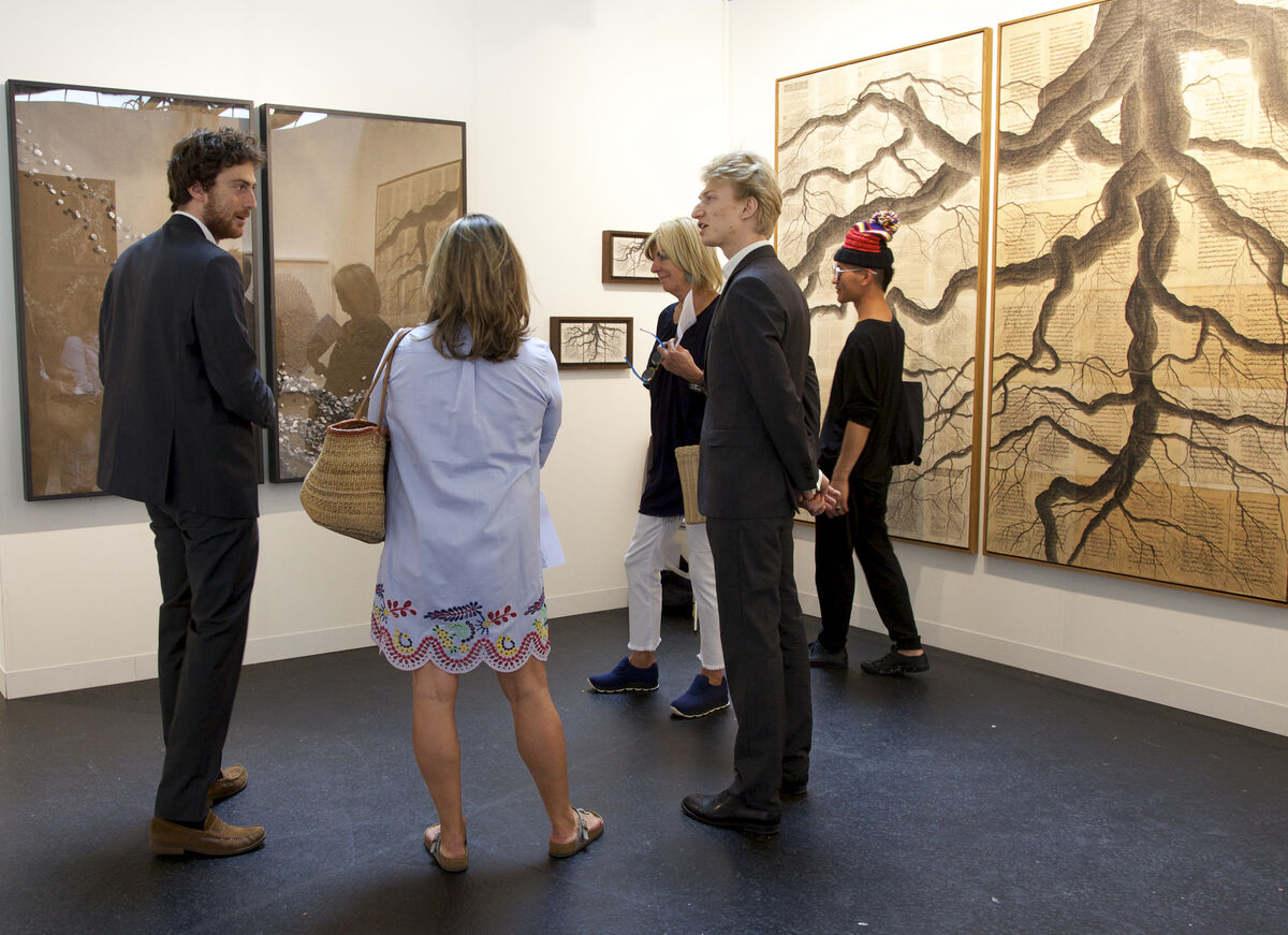 Tancrède Hertzog (left) and Léopold Legros (center), co-owners of Galerie T&amp;L (Paris) hold court in a solo booth project by Tindar; courtesy VOLTA13