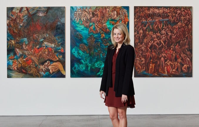 Head of Sale Rebekah Bowling poses in front of Nicole Eisenman&#x27;s, Foos Ball Trilogy