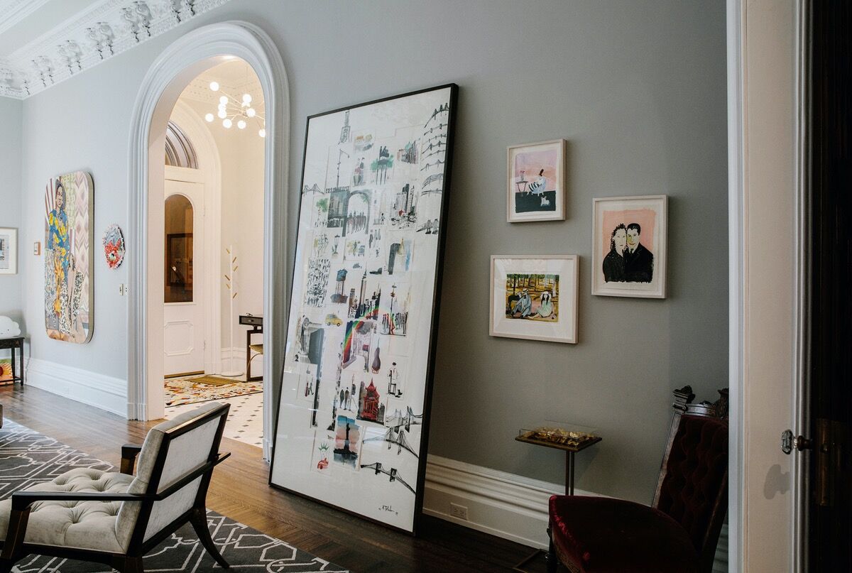 Installation view, from left to right, of a large collage work by Ruben Toledo and paintings by Maira Kalman. Photo by Laurel Golio for Artsy.