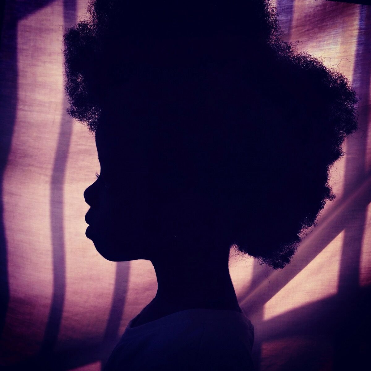 Afro on purple. Silhouette of my daughter. Accra, Ghana. Photo by @africashowboy.