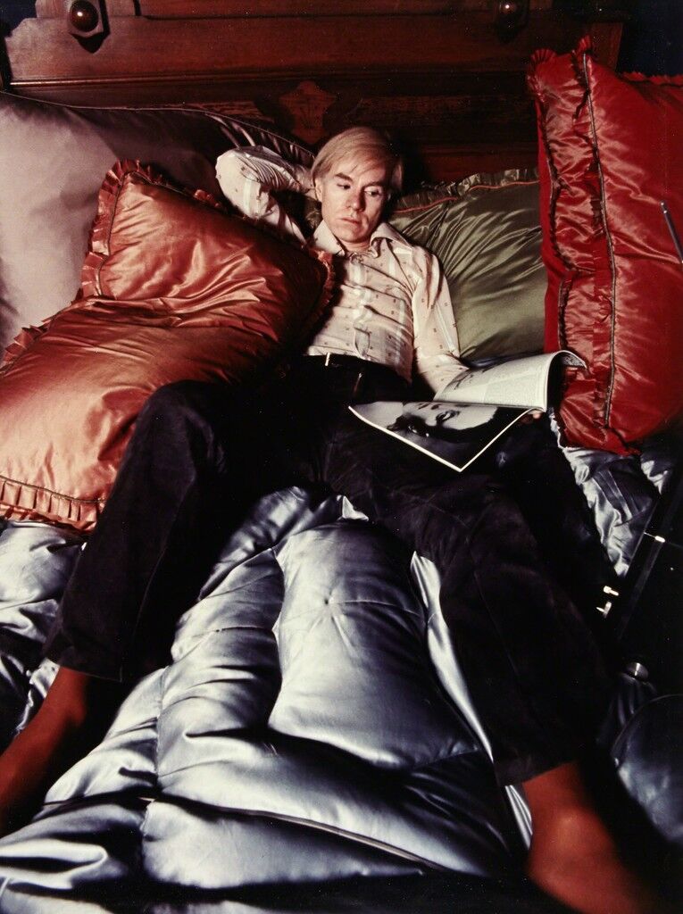 [Andy Warhol on his bed]