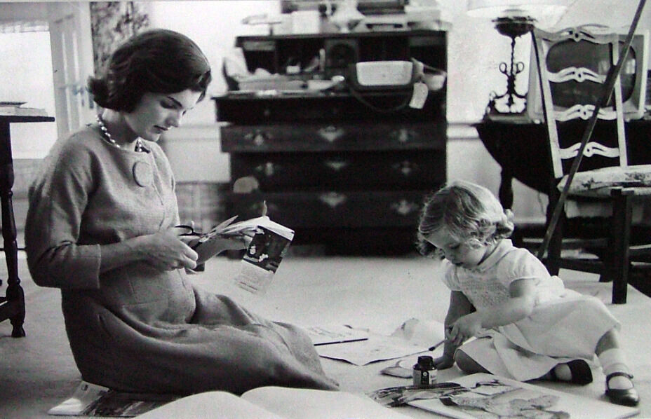 Jacqueline Kennedy, Wife of Senator with Scissors Cutting Out Newspaper Clippings Next to Open Scrapbook as Her Young Daughter Caroline Toys with the Applicator from a Glue Bottle, At Home, Hyannis Port, MA